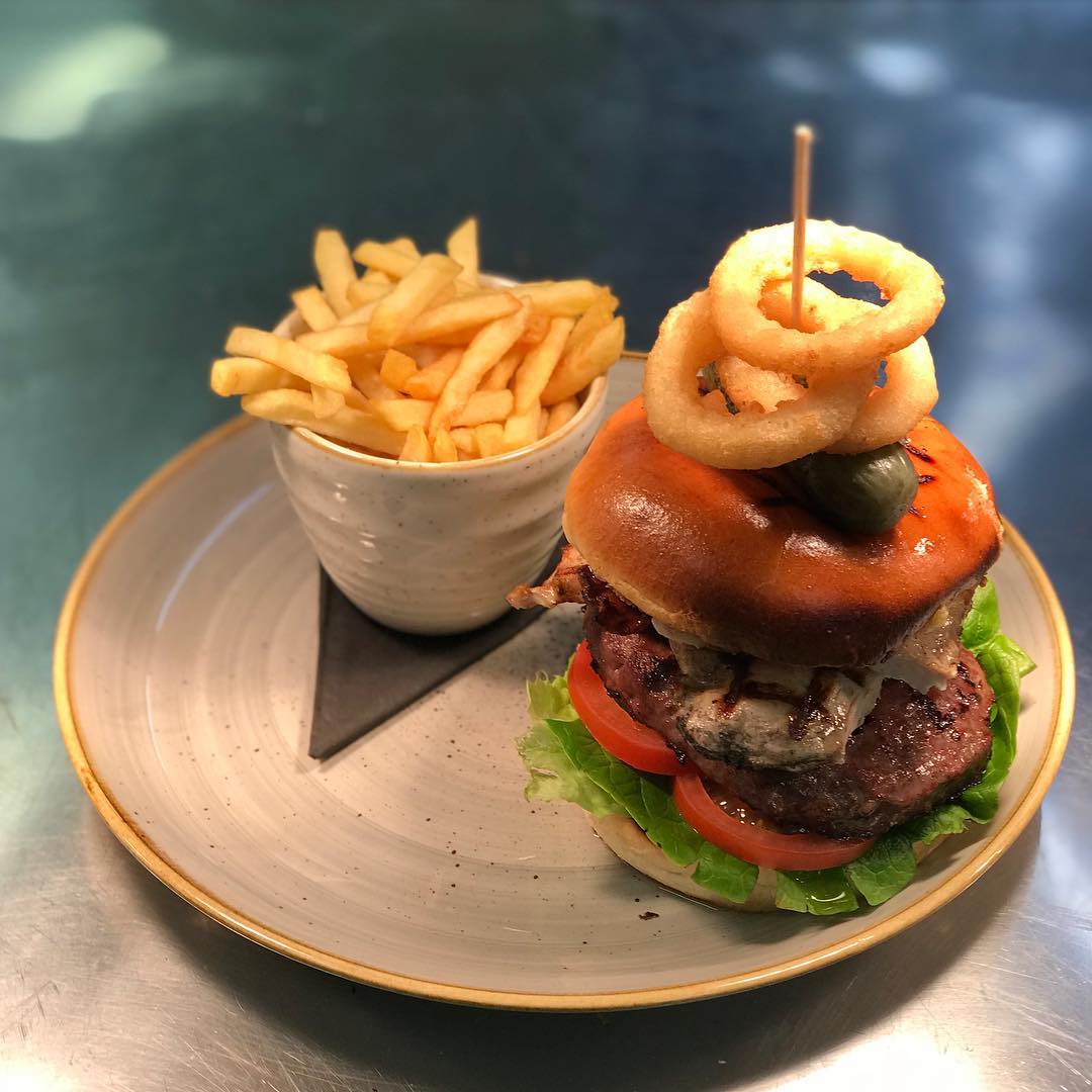 The Ultimate Burger… Wow. Steak burger, chicken breast, bacon, cheese & onion rings with some fries for good measure. Tag a friend who’d destroy this… .
.
#cafeoswalds #food #foodie #burger #steak #cranstons #cumbria #lakedistrict #penrith #carlisle
